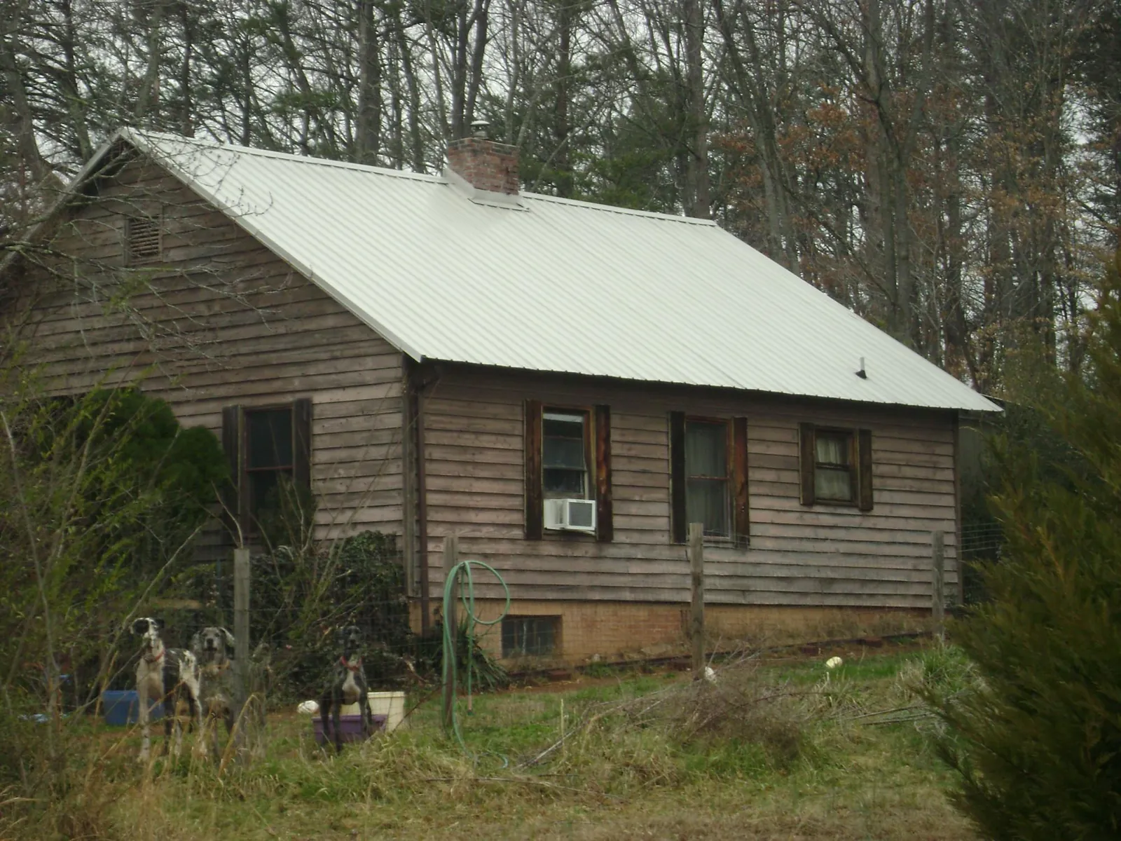 White metal roof on an old wood sided farmhouse, from a Asphalt Shingle Roof Repair job in Lorraine